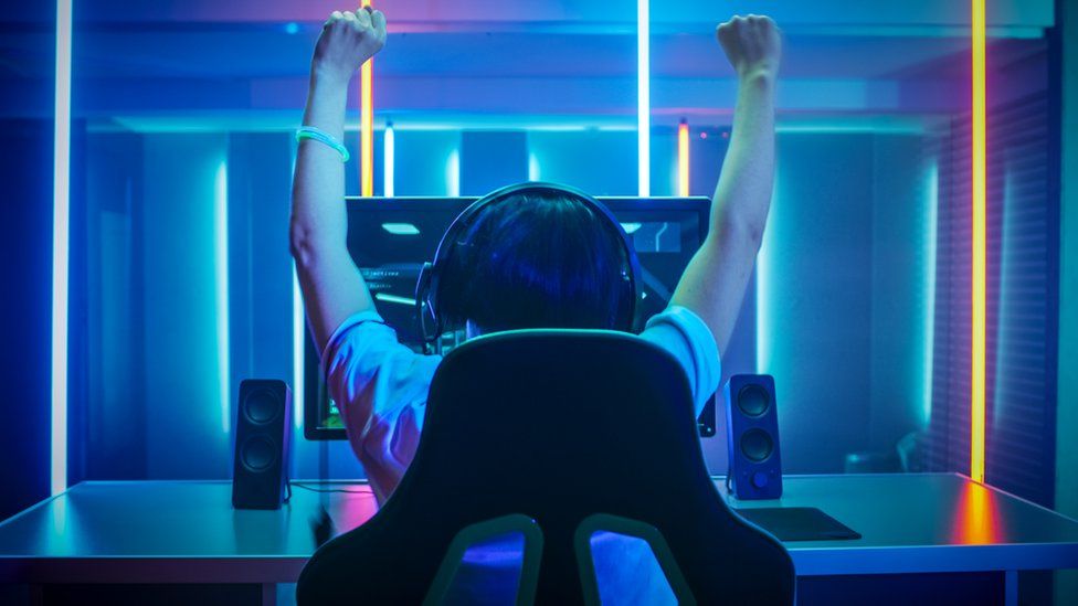 A-YOUNG-PERSON-GAMING-AND-CHEERING.