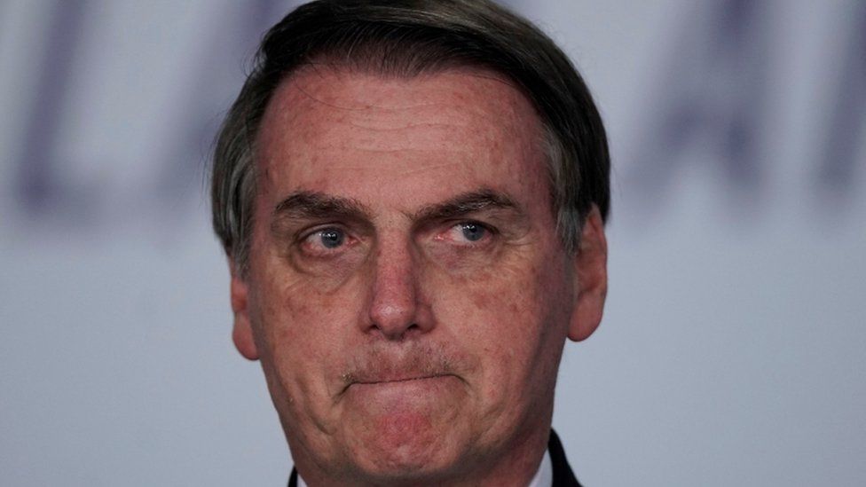 Mr Bolsonaro looking disappointed at an event on March 25