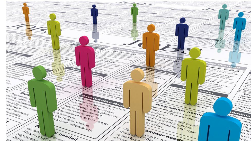 Colourful figures standing on newspaper job adverts