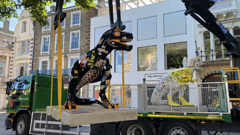 Dinosaur statues being put in place