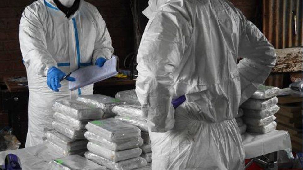 Forensic investigators by a stash of drugs