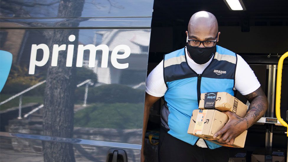 An Amazon driver delivers packages in Northeast Washington, DC, on Tuesday, 6 April 2021