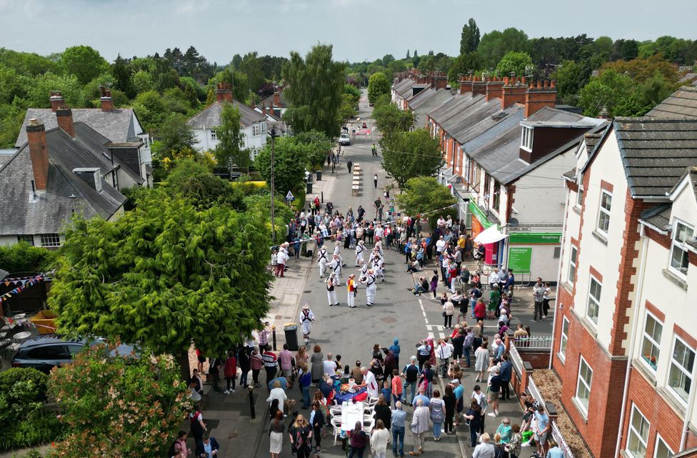 Residents watch Morris dancers during the Knighton Church Road street party on 3 June 2022 in Leicester