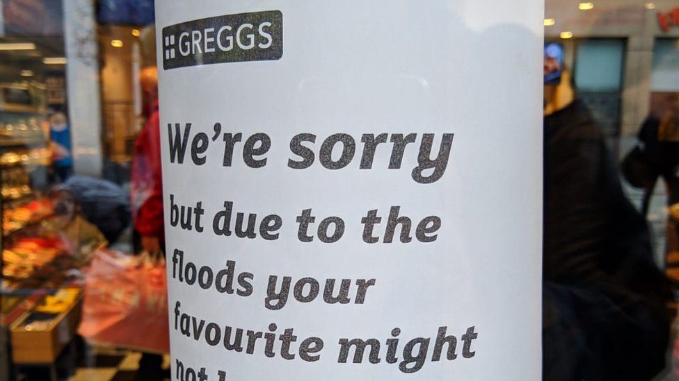 A poster in a branch of Greggs warning customers of product shortages due to flooding