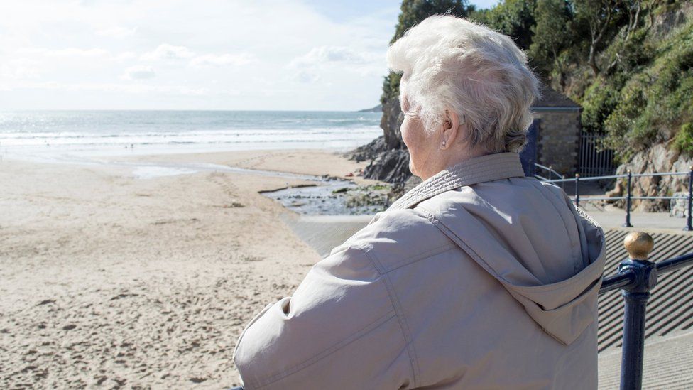 Older woman looking out to sea