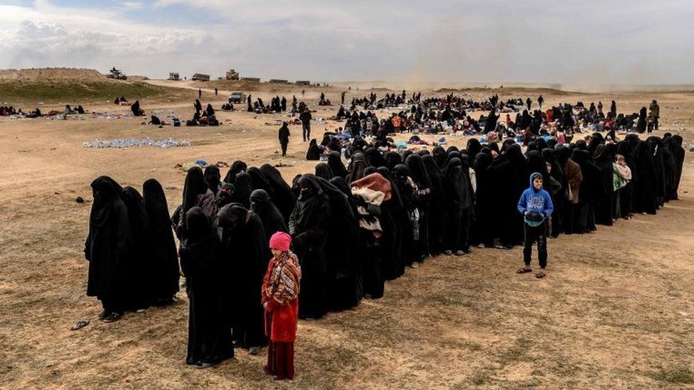Civilians evacuated from the Islamic State (IS) group's embattled holdout of Baghuz wait at a screening area held by the US-backed Kurdish-led Syrian Democratic Forces (SDF), in the eastern Syrian province of Deir Ezzor, on March 5, 2019