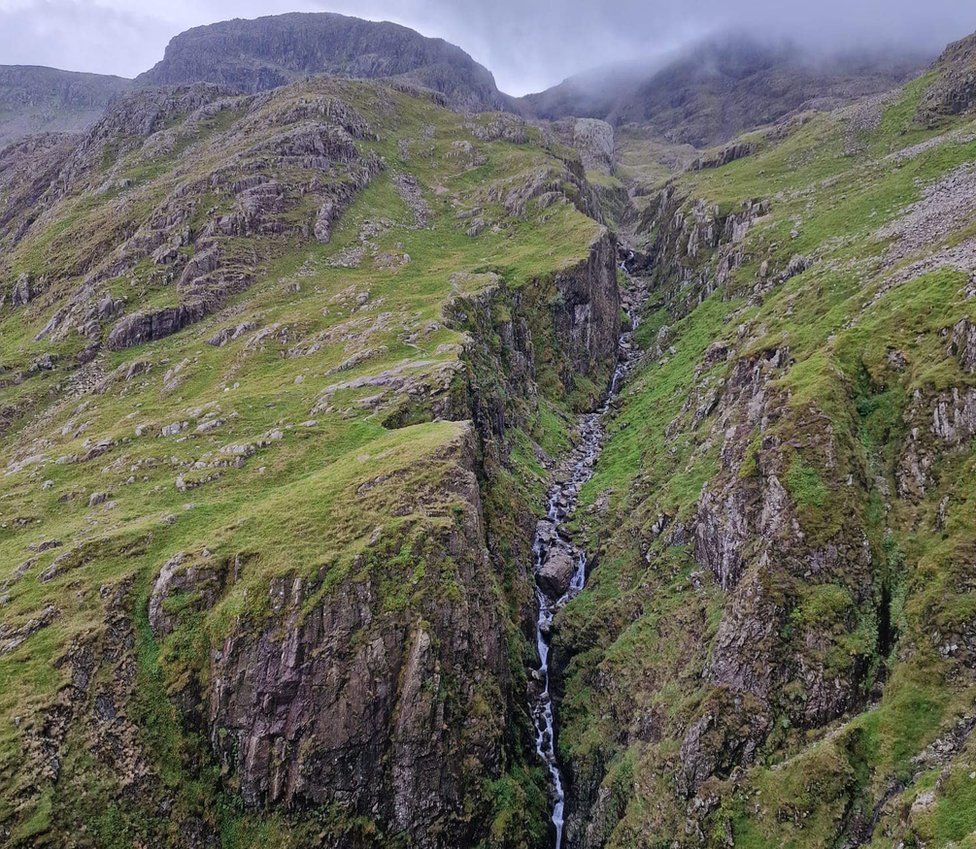 A steep gully down a mountainside