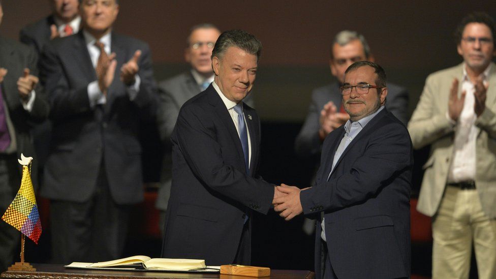 Colombian President Juan Manuel Santos (L) and the head of the Farc guerrilla Timoleon Jimenez, aka Timochenko, shake hands during the second signing of the historic peace agreement between the Colombian government and Farc, 24 November 2016