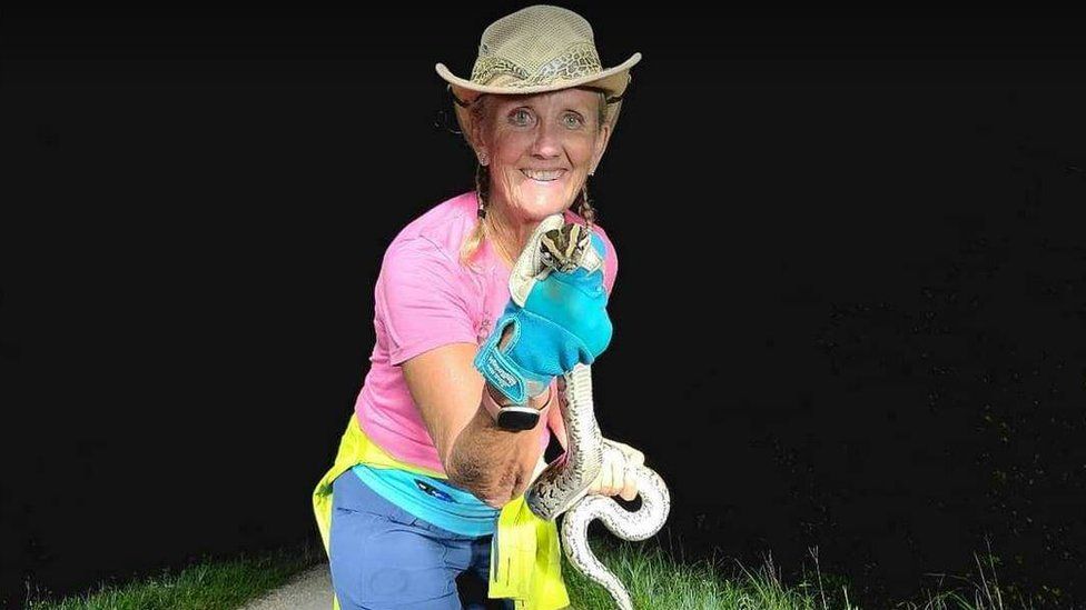 Marcia Carlson Pack with a python she caught