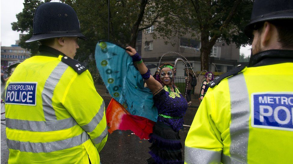 Police officers look on at teh Notting Hill Carnival