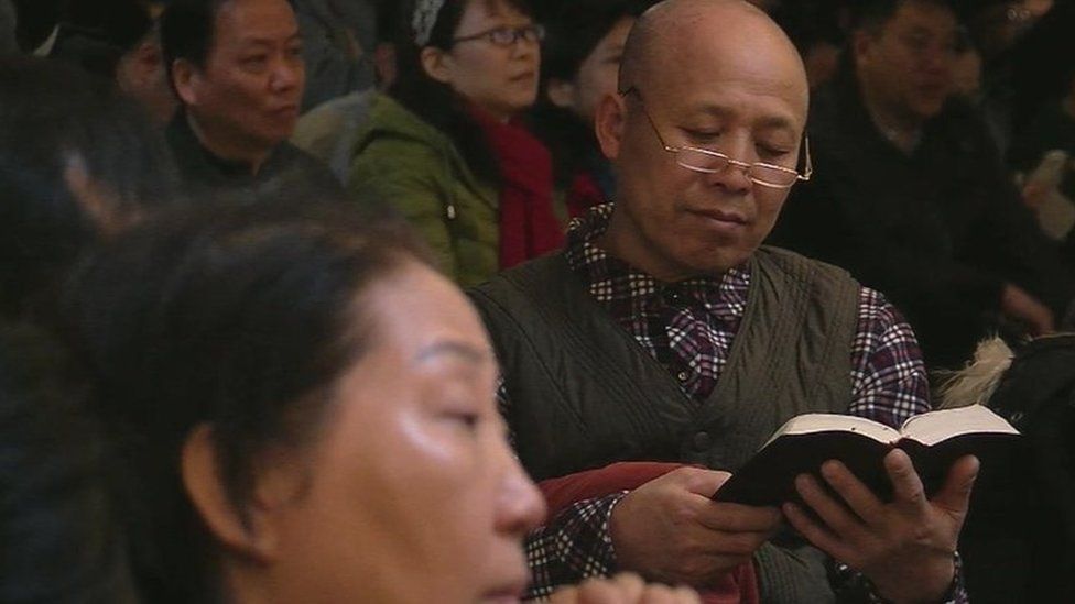 Christian prays at an official church in Beijing