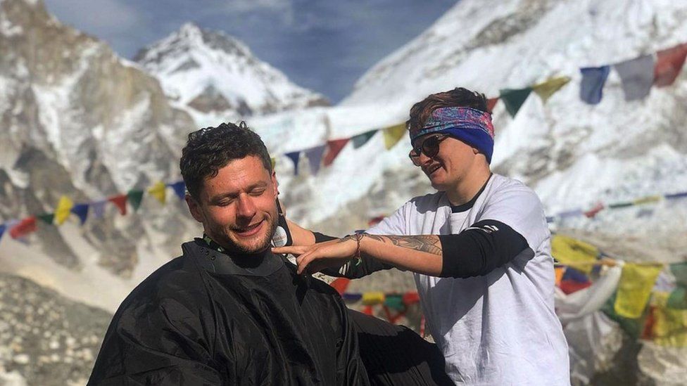 Man getting his hair cut on Mount Everest