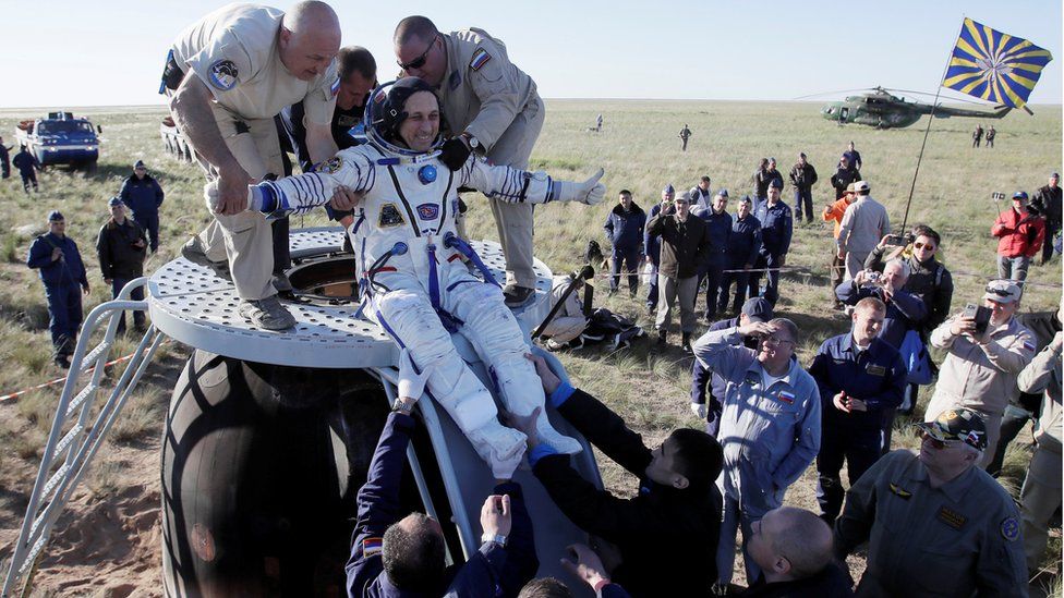 Ground crew help Anton Shkaplerov of Russia to get out of the Soyuz space capsule shortly after landing in Kazakhstan. 3 June 2018