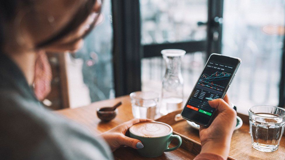 woman using smartphone to buy crypto