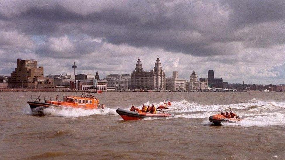 lifeboats sail past Liverpool Pier Head
