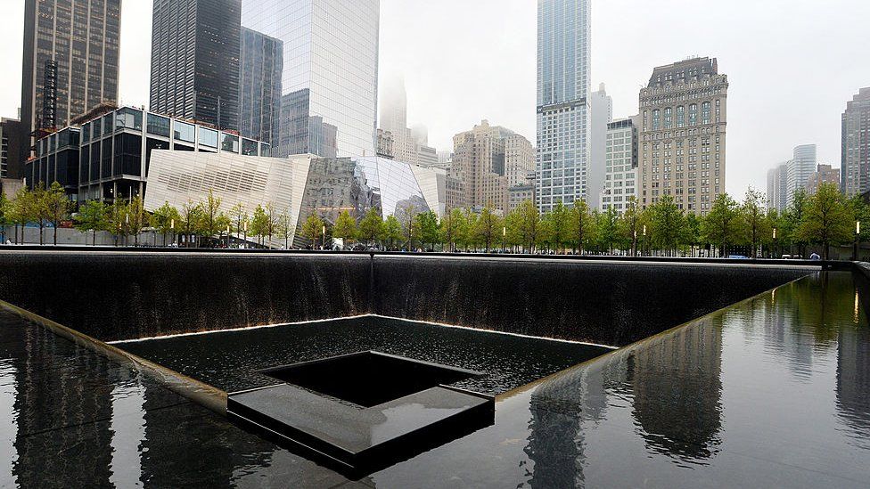 The National September 11 Memorial Museum stands beyond the north reflecting pool