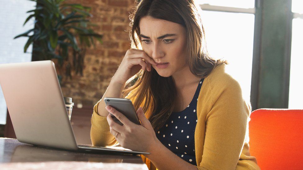 Stock image of businesswoman looking at phone