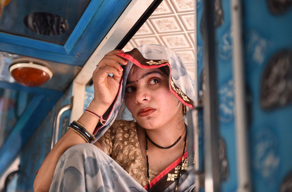 A female migrant worker from Uttar Pradesh sits inside a bus leaving Gujarat after attacks on migrants following the rape of a 14-month-old baby