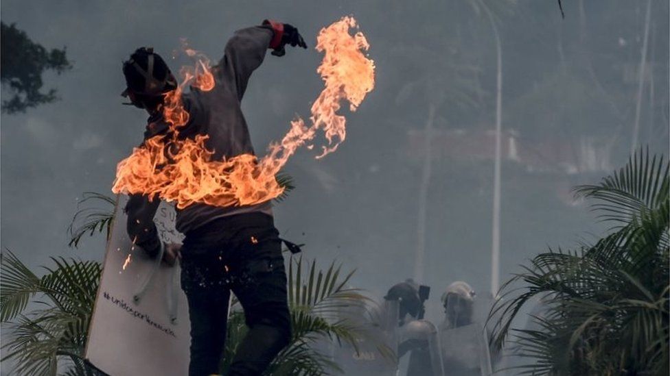 An opposition activist clashes with riot police during a demonstration against the government of President Nicolas Maduro along the Francisco Fajardo highway in Caracas on June 19, 2017.