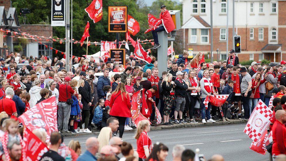 Several fans have lined the route through Liverpool