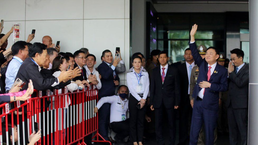Former Thai prime minister Thaksin Shinawatra greets supporters as he arrives at Don Mueang International Airport on August 22, 2023 in Bangkok, Thailand.