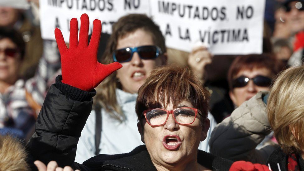 Protesters hold banners that read "Trial against defendants, not against the victim" during a protest held at the Superior Court of Navarra