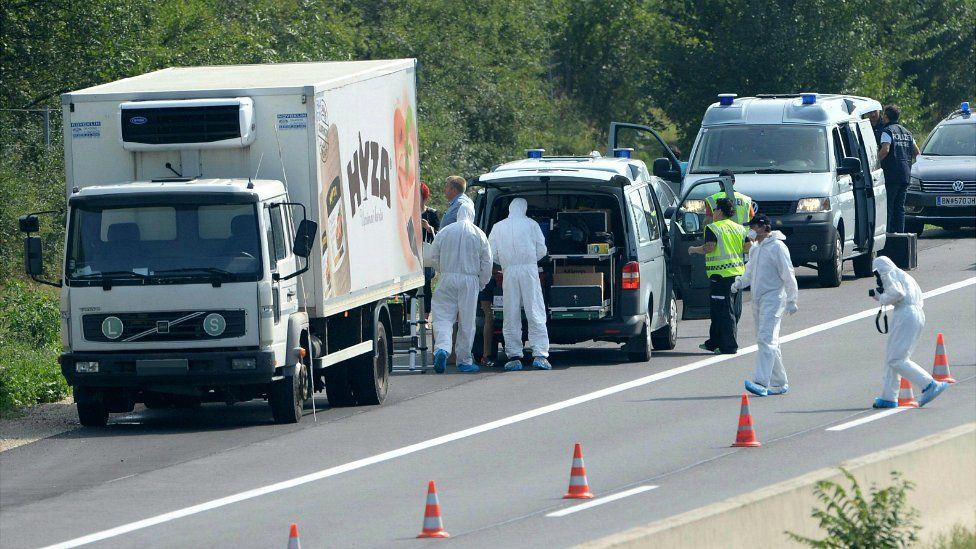 Forensic experts investigate a lorry in which several people were found dead on the A4 motorway in Austria - 27 August 2015