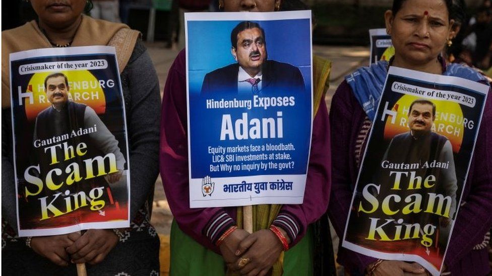 Activist of the youth wing of India"s main opposition Congress party hold placards featuring Gautam Adani, Chairman of Adani Group, during a protest against what they say are investments by Life Insurance Corporation (LIC) and State Bank of India (SBI) in Adani Group, in New Delhi, India, February 6, 2023.