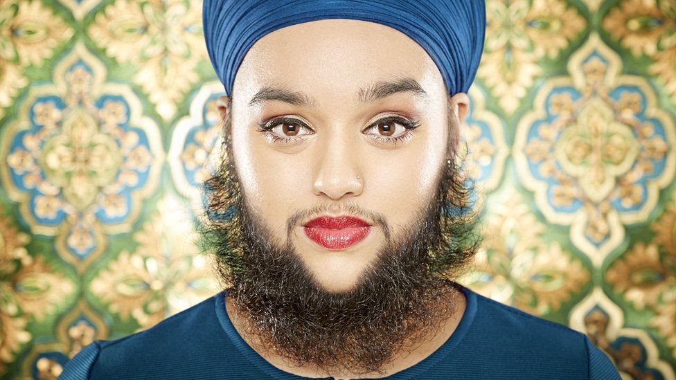 Young woman with full beard