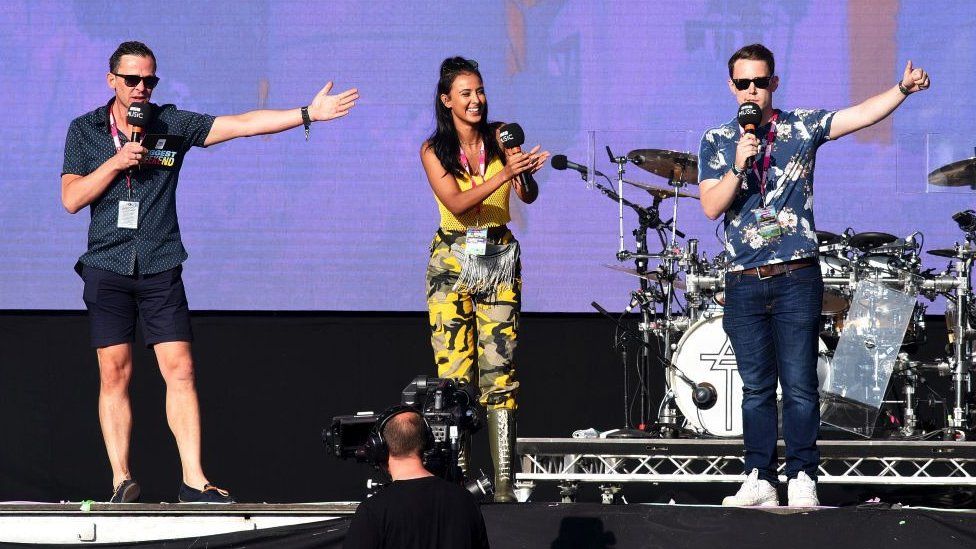 Scott Mills, Maya Jama and Chris Stark on stage at Radio 1's Big Weekend