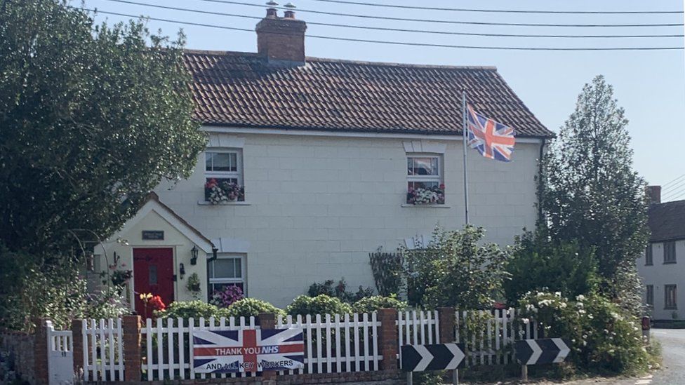 House with flag outside it