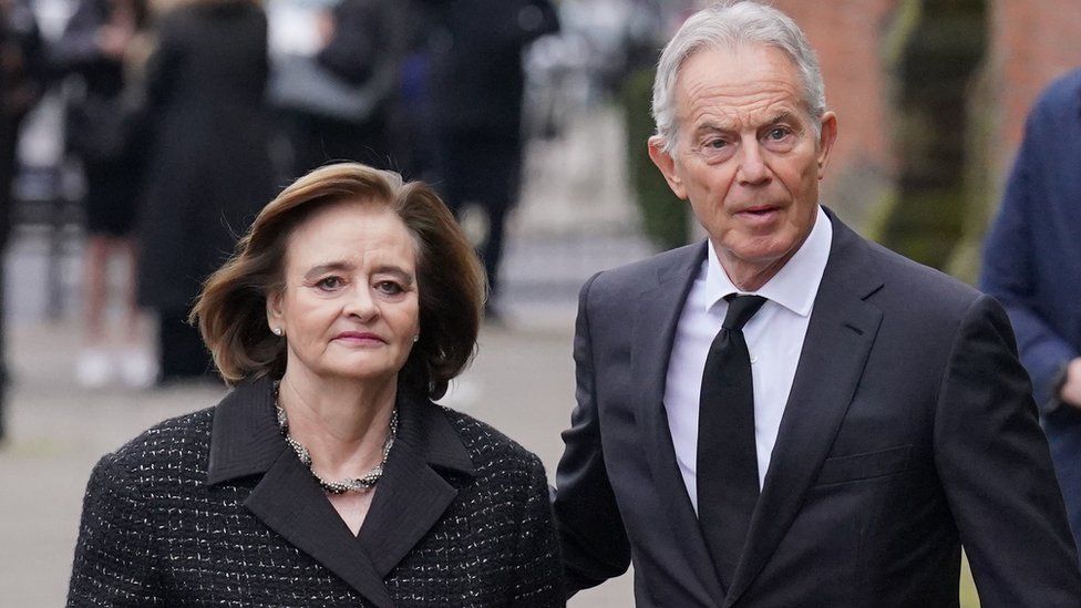 Former prime minister Tony Blair and his wife Cherie Blair attend the funeral service of Derek Draper