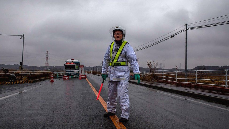 A policeman stands guard at one of the entrances to the 20km evacuation zone surrounding the tsunami-crippled Fukushima Dai-ichi nuclear plant on March 09, 2012 in Minamisoma in Fukushima Prefecture,