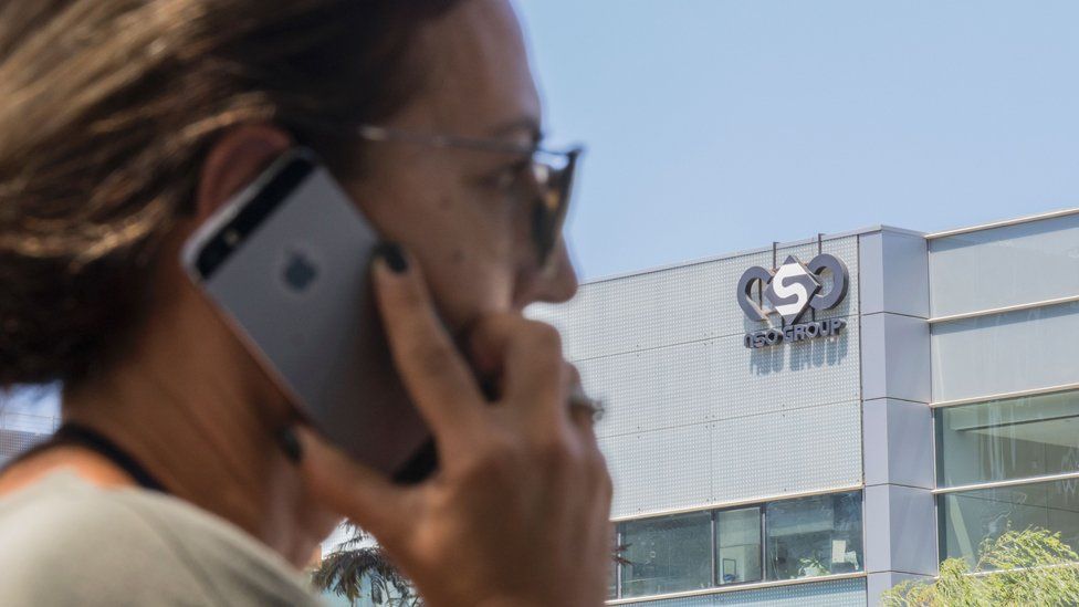 An Israeli woman uses her iPhone in front of the building housing the Israeli NSO group, on August 28, 2016