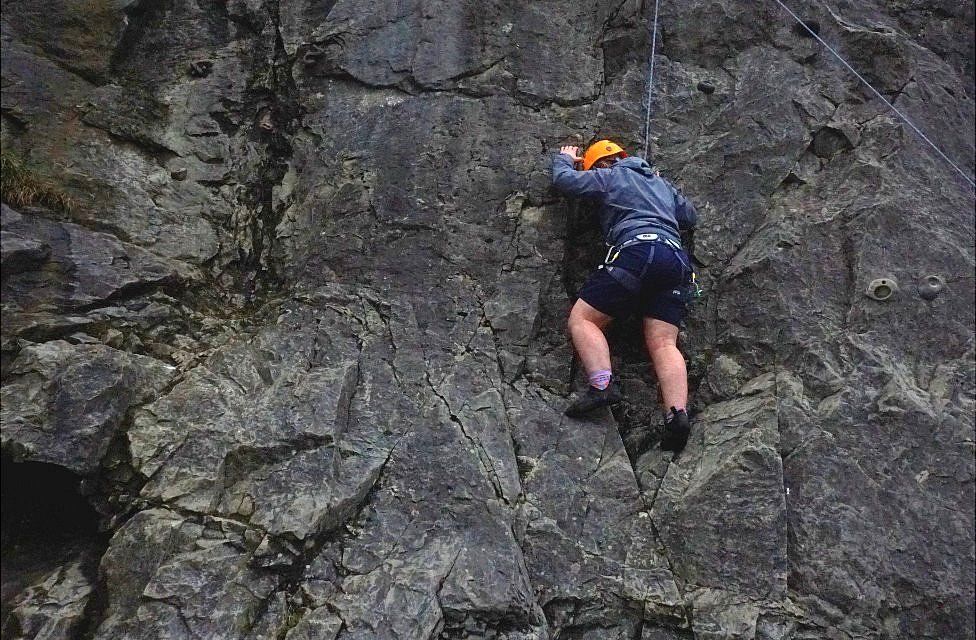 Charlotte Boulton climbing a route