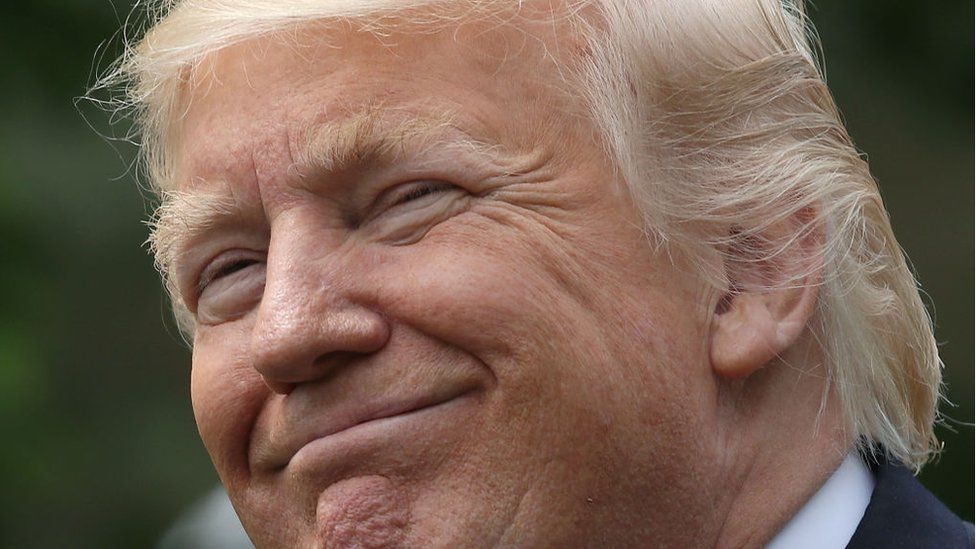 Donald Trump smiles.
