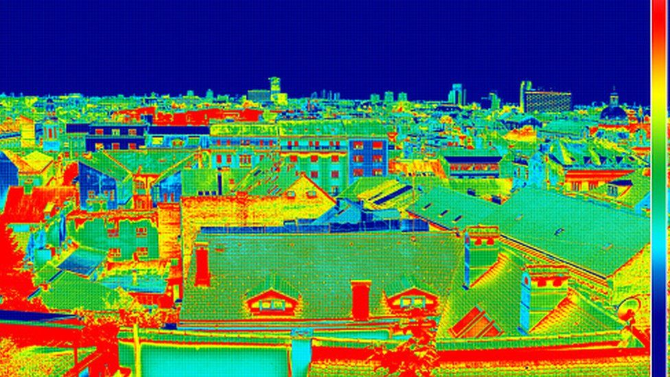 A wide shot of a housing estate seen through a thermal imaging camera.