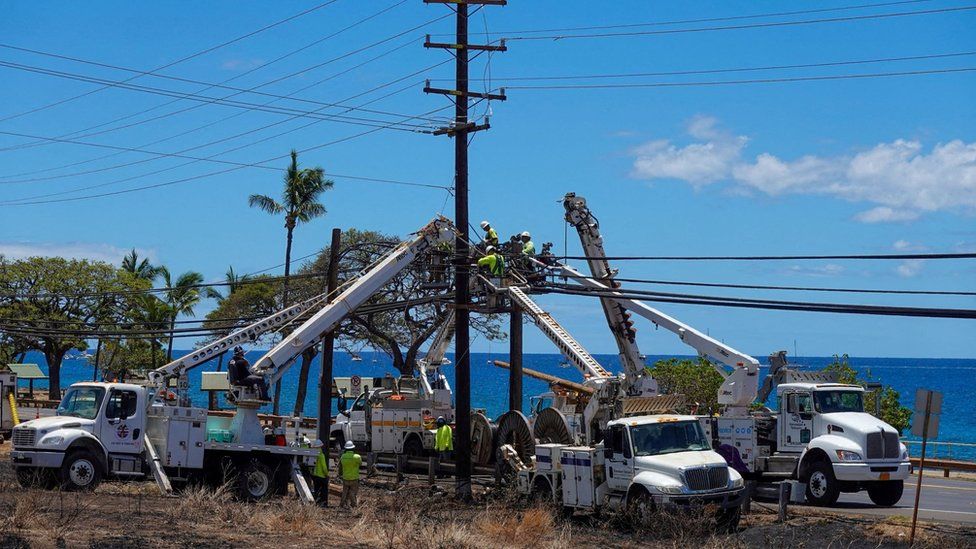 Workers repairing utility lines in the fire-ravaged town of Lahaina on Maui, Hawaii
