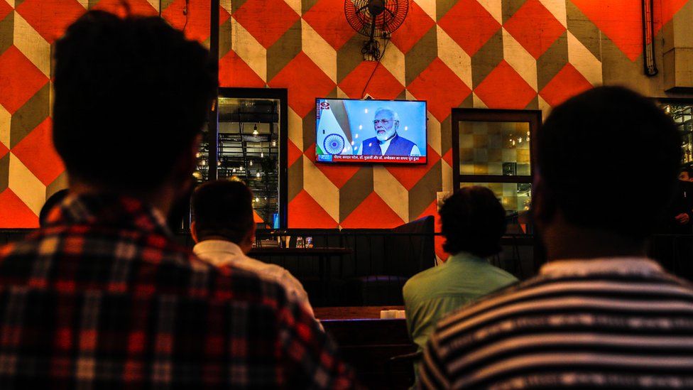 People watch a live address by Indian Prime Minister Narendra Modi after the government scrap Article 370, at a restaurant in Mumbai, India, 08 August 2019