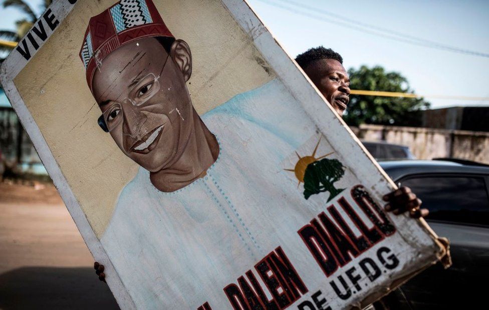 A supporter holds up a painting of main opposition candidate, Cellou Dalein Diallo in Conakry on October 14, 2020.