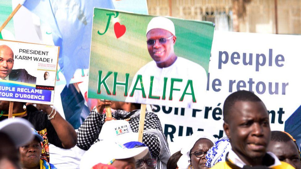 Supporters of Khalifa Sall hold placards expressing their love for him in a May 2019 protest