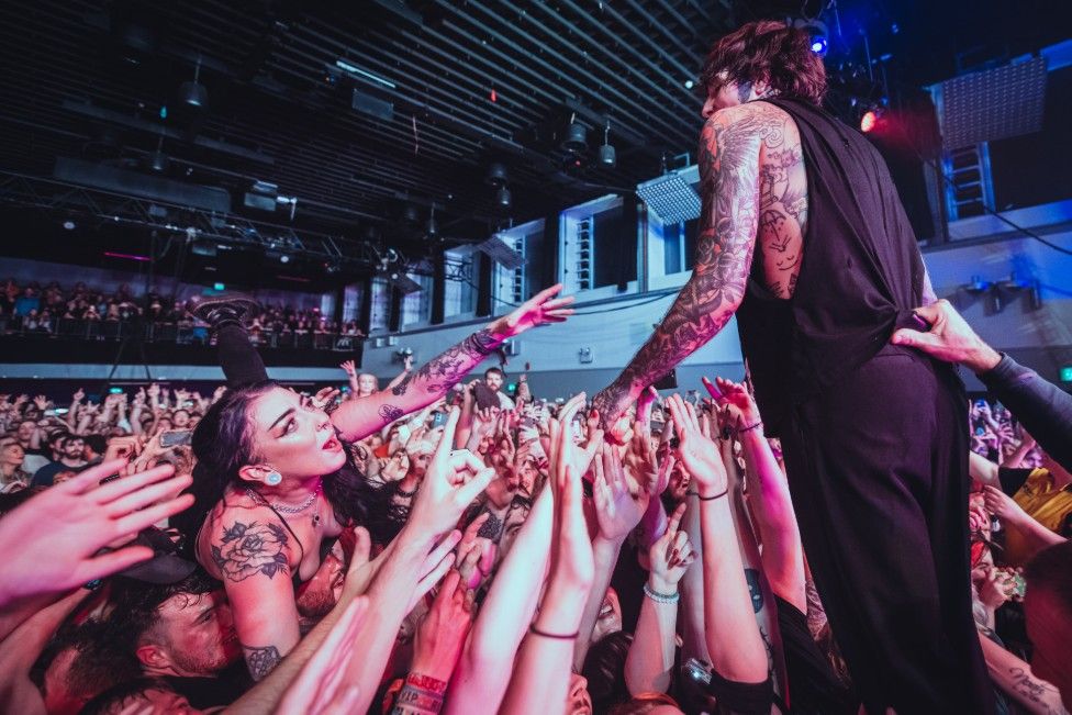 Fan reaches for a singer at a gig