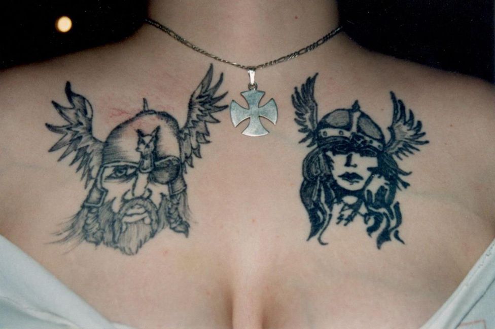 Angela's chest with two tattoos inspired by Norse mythology