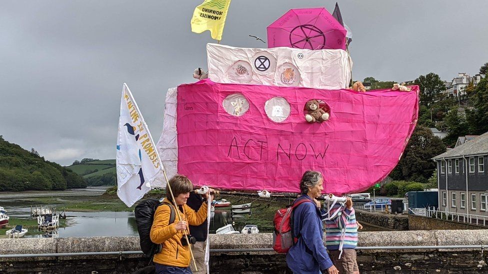 Climate activists with a pink boat