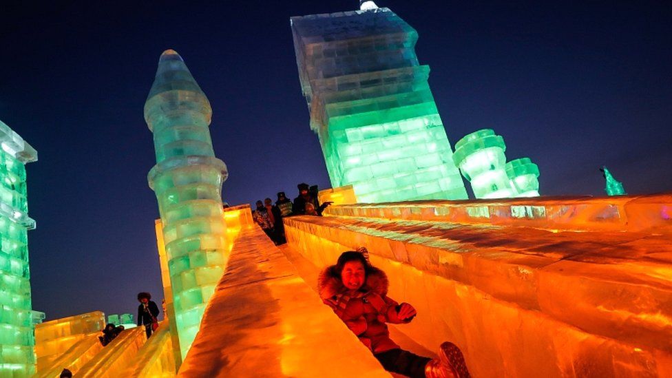 Uma crianÃ§a monta um escorregador de uma escultura de gelo do Mundo do Gelo e da Neve durante o Festival Internacional de Escultura de Gelo e Neve de Harbin, em Harbin, China, em 4 de janeiro de 2019