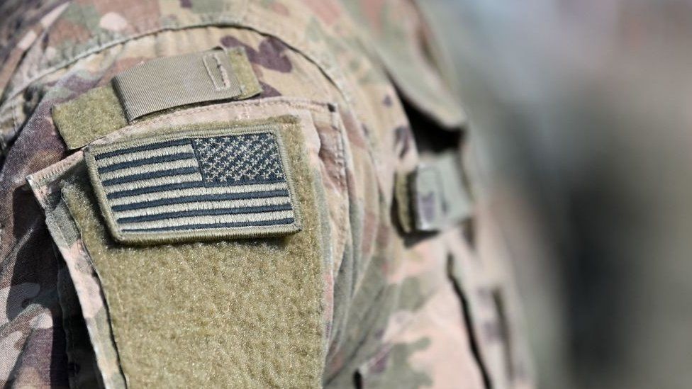 A US flag on a camo uniform