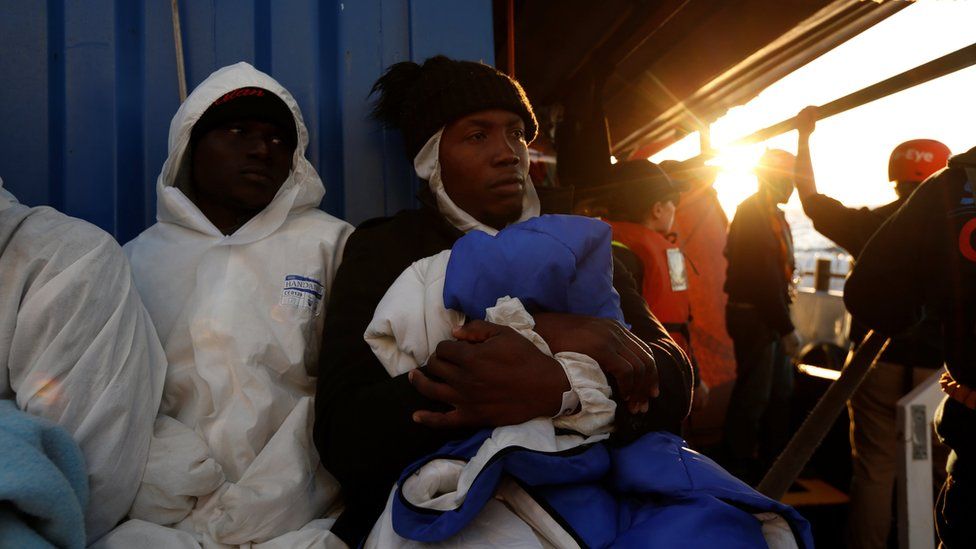 Rescued migrants rest on the migrant rescue ship "Alan Kurdi"