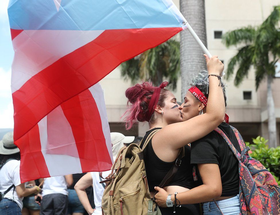 Two women embrace in Old San Juan, Puerto Rico