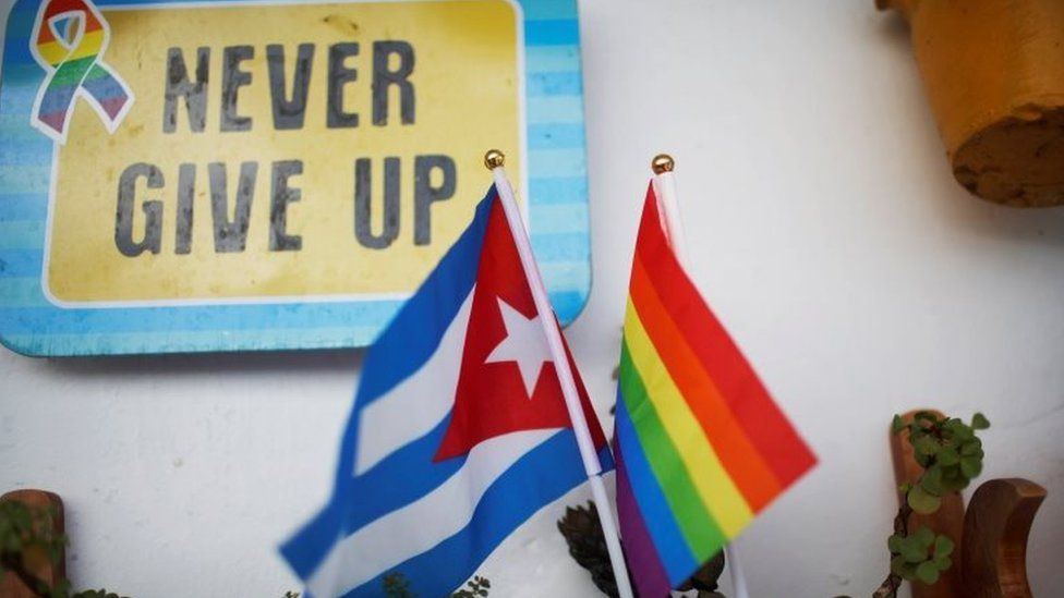 A Cuban flag and a Pride rainbow flag symbolising gay rights are seen at the balcony of the apartment of same-sex couple Mercedes Garcia and Onelia Miranda in Havana, Cuba August 10, 2018