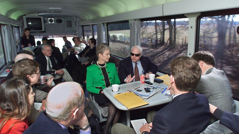 Republican presidential hopeful US Senator John McCain, (R-AZ), and his wife Cindy, (L), speak with reporters as they travel from Columbia to Sumter, South Carolina 07 Jan 2000